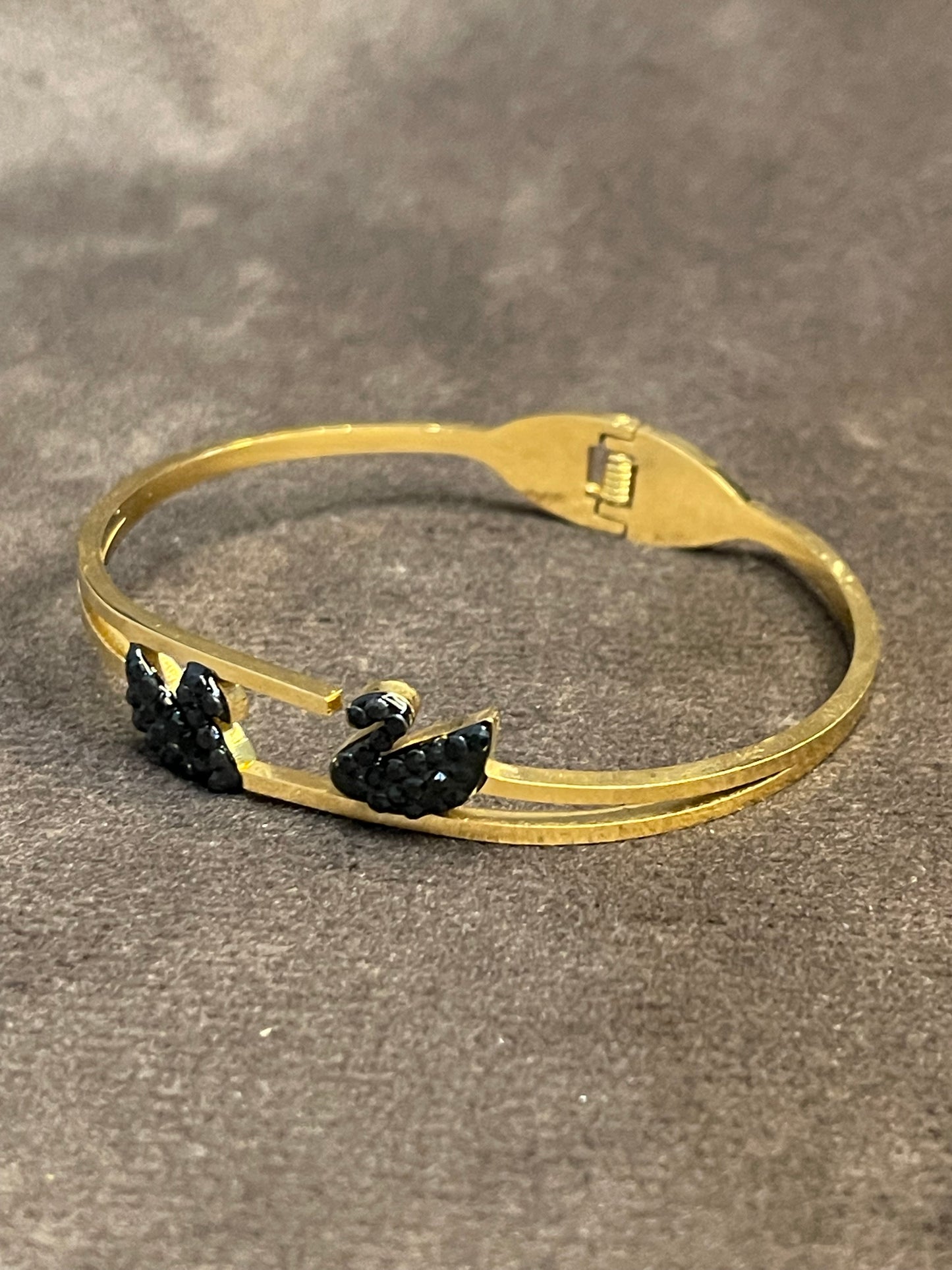 Gold bangles with two black decorative ducks