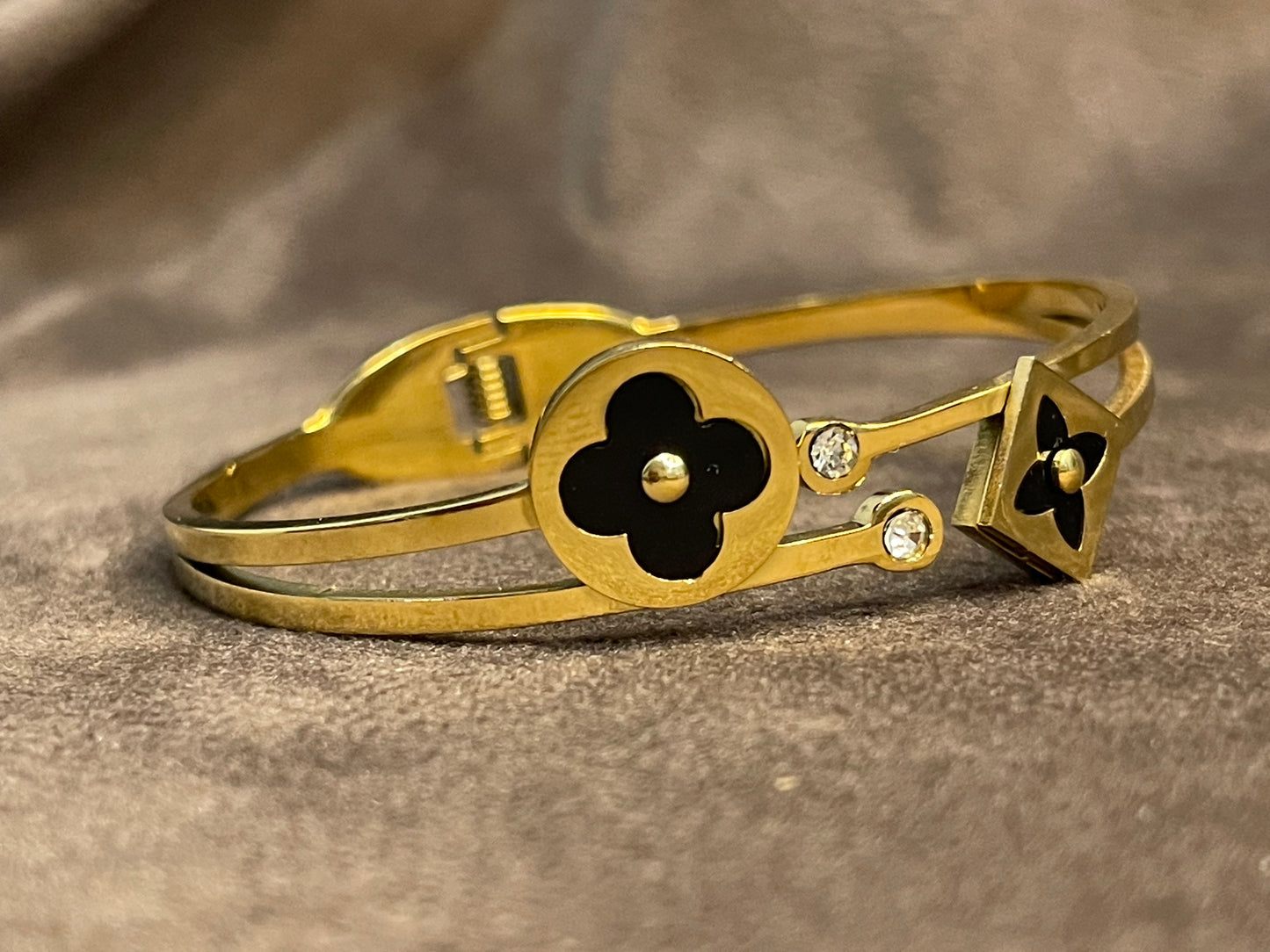 Elegant Gold Bangle with Black Floral motifs.