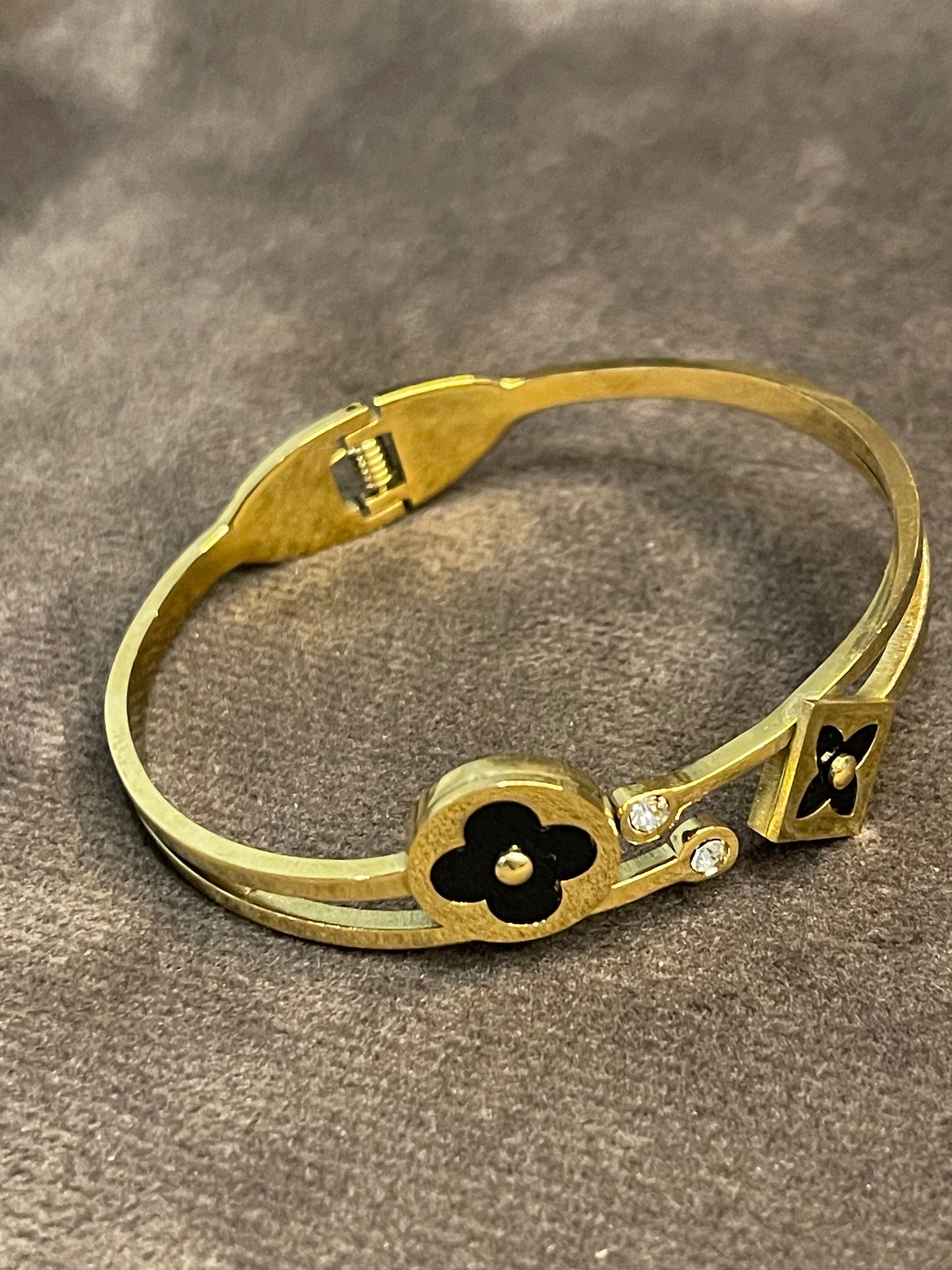 Elegant Gold Bangle with Black Floral motifs.
