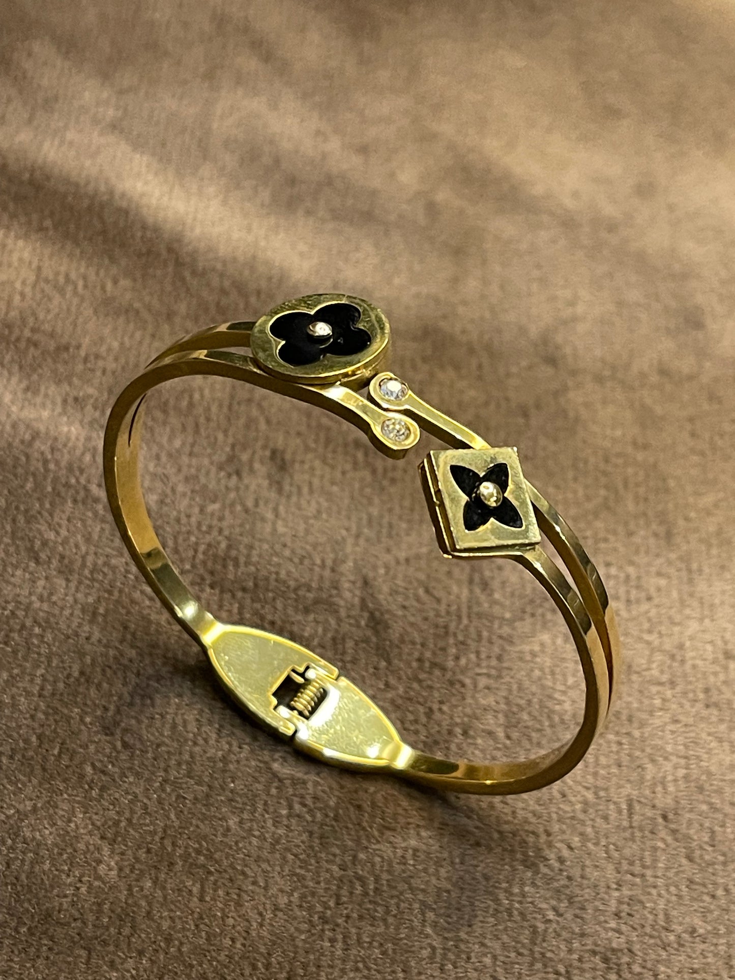 Elegant Gold Bangle with Black Floral motifs.