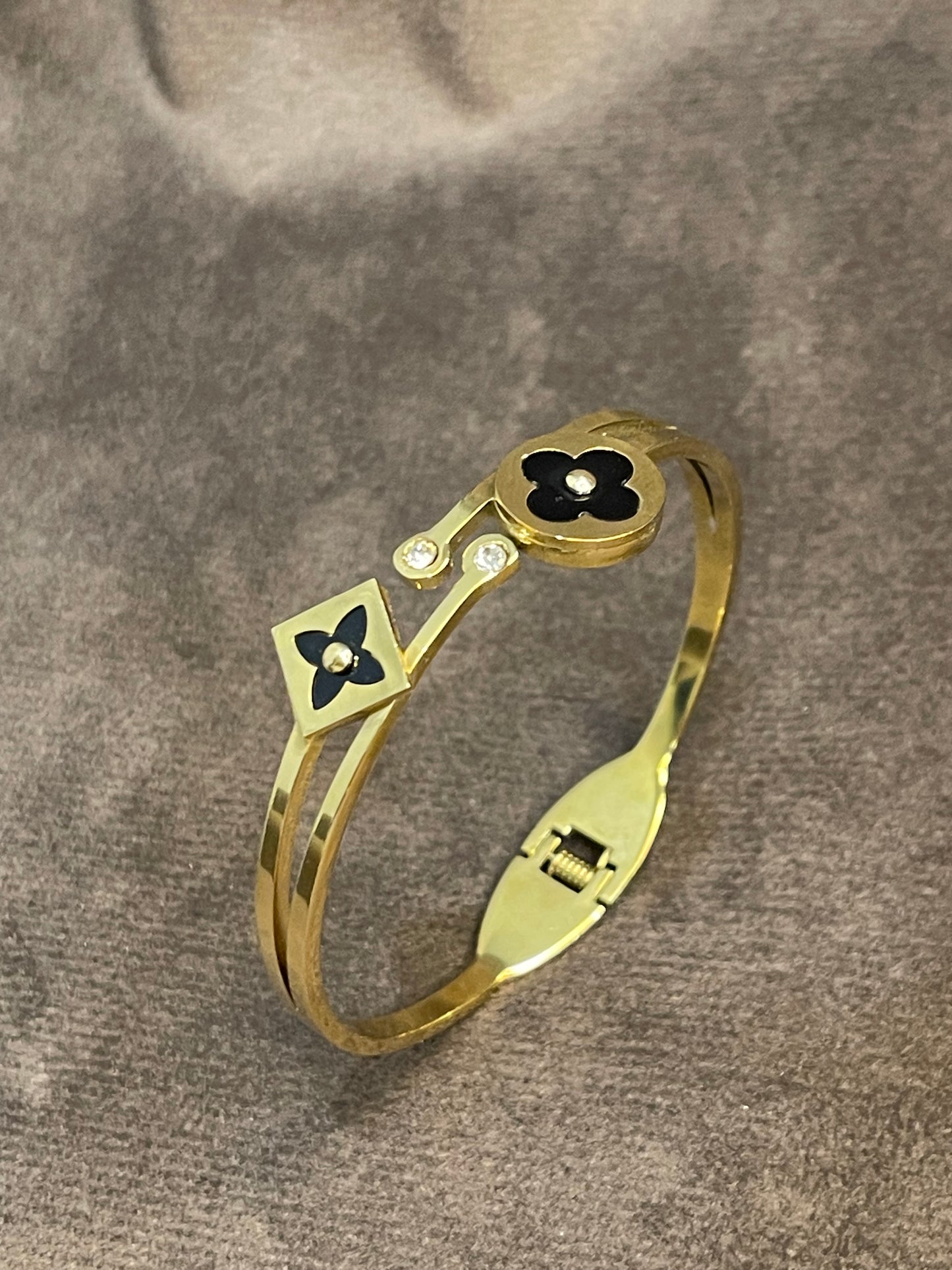 Elegant Gold Bangle with Black Floral motifs.
