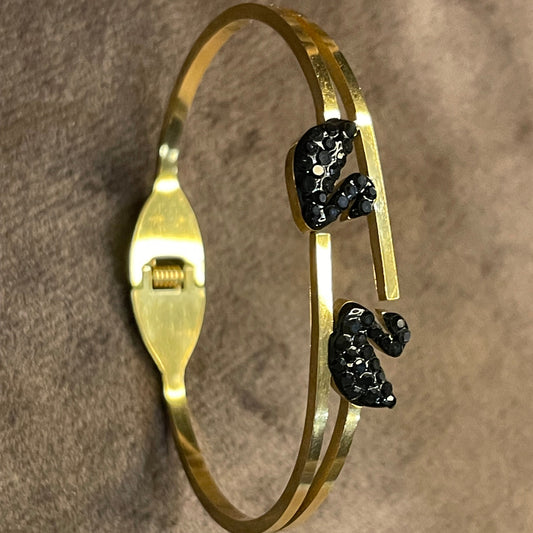 Gold bangles with two black decorative ducks
