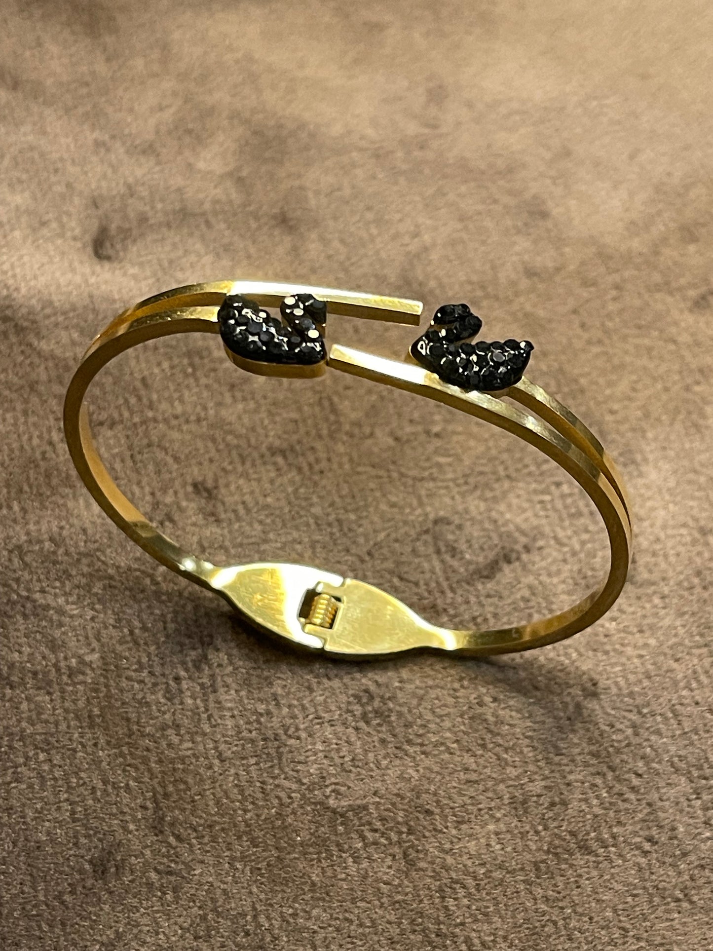 Gold bangles with two black decorative ducks