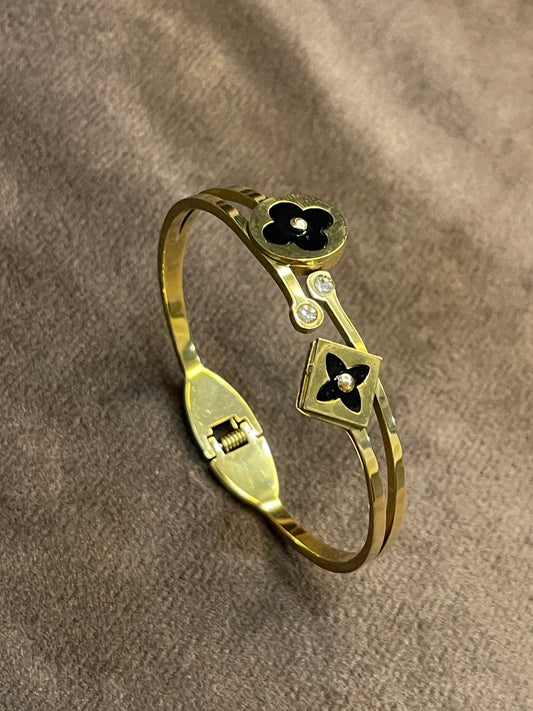 Elegant Gold Bangle with Black Floral motifs.