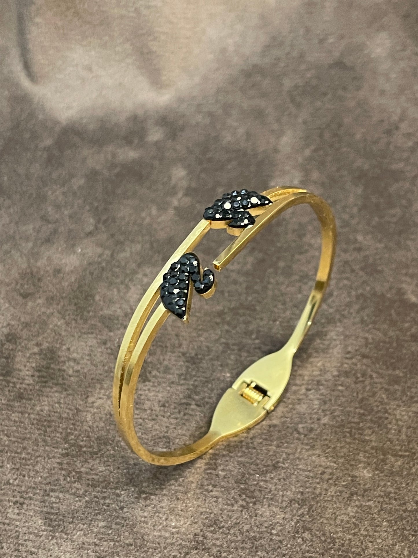Gold bangles with two black decorative ducks