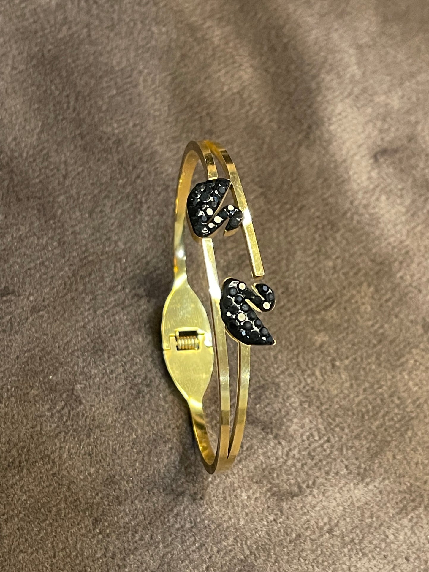 Gold bangles with two black decorative ducks