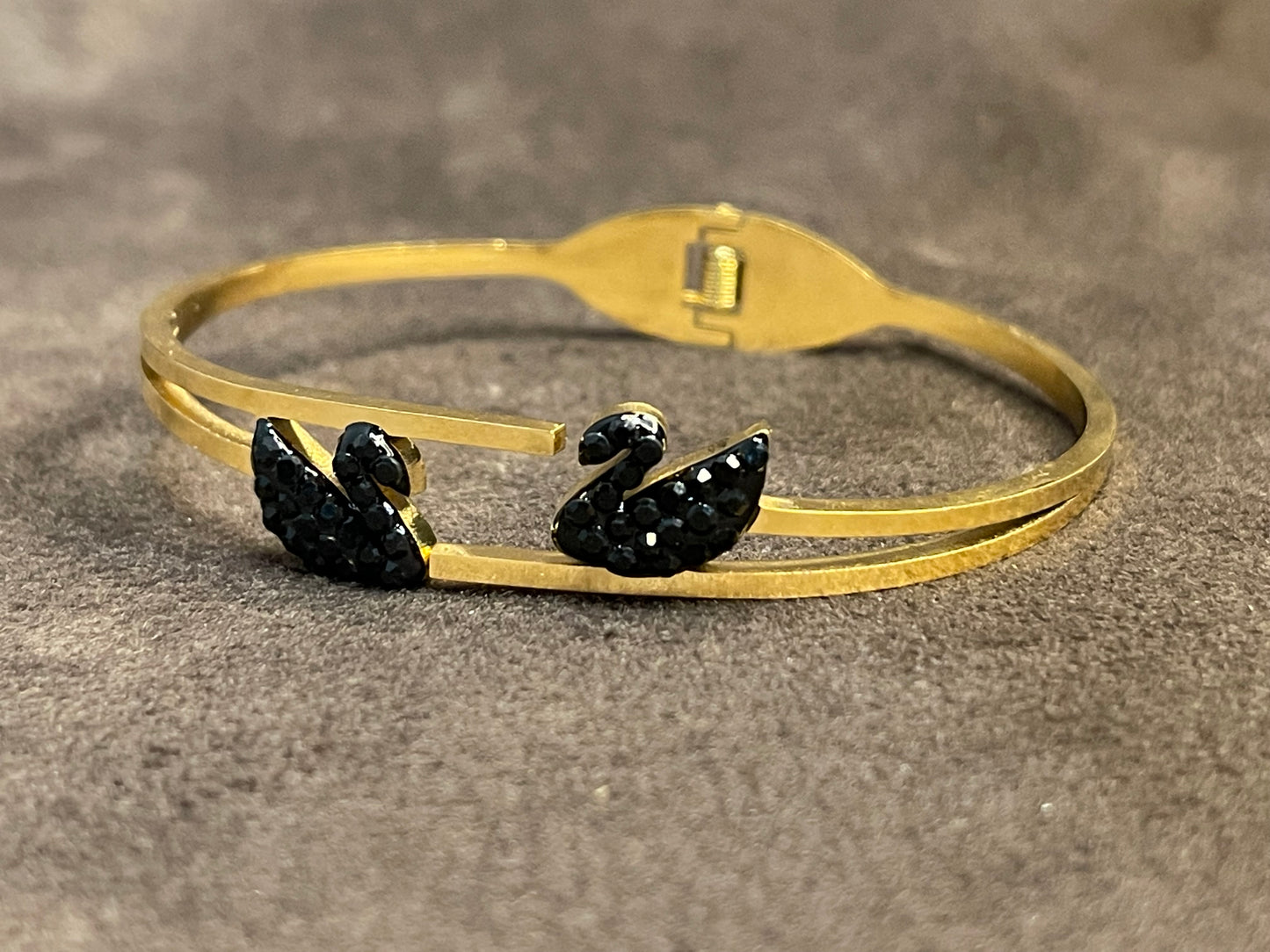 Gold bangles with two black decorative ducks