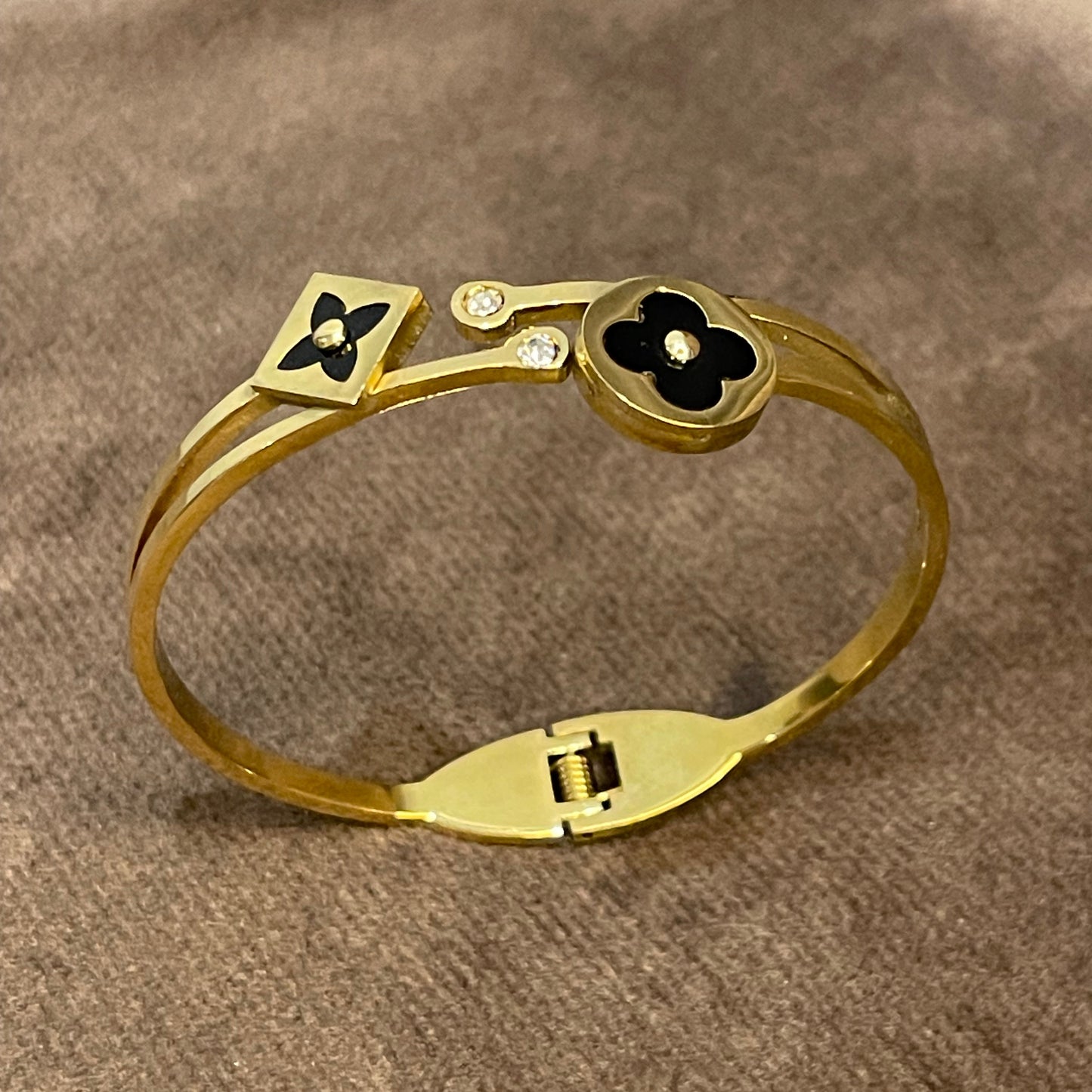 Elegant Gold Bangle with Black Floral motifs.