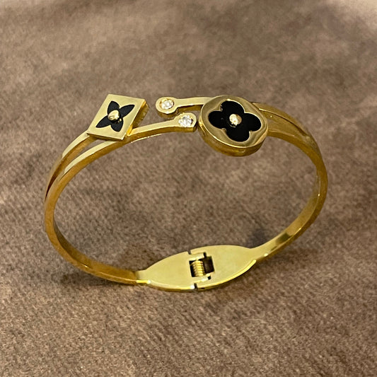 Elegant Gold Bangle with Black Floral motifs.