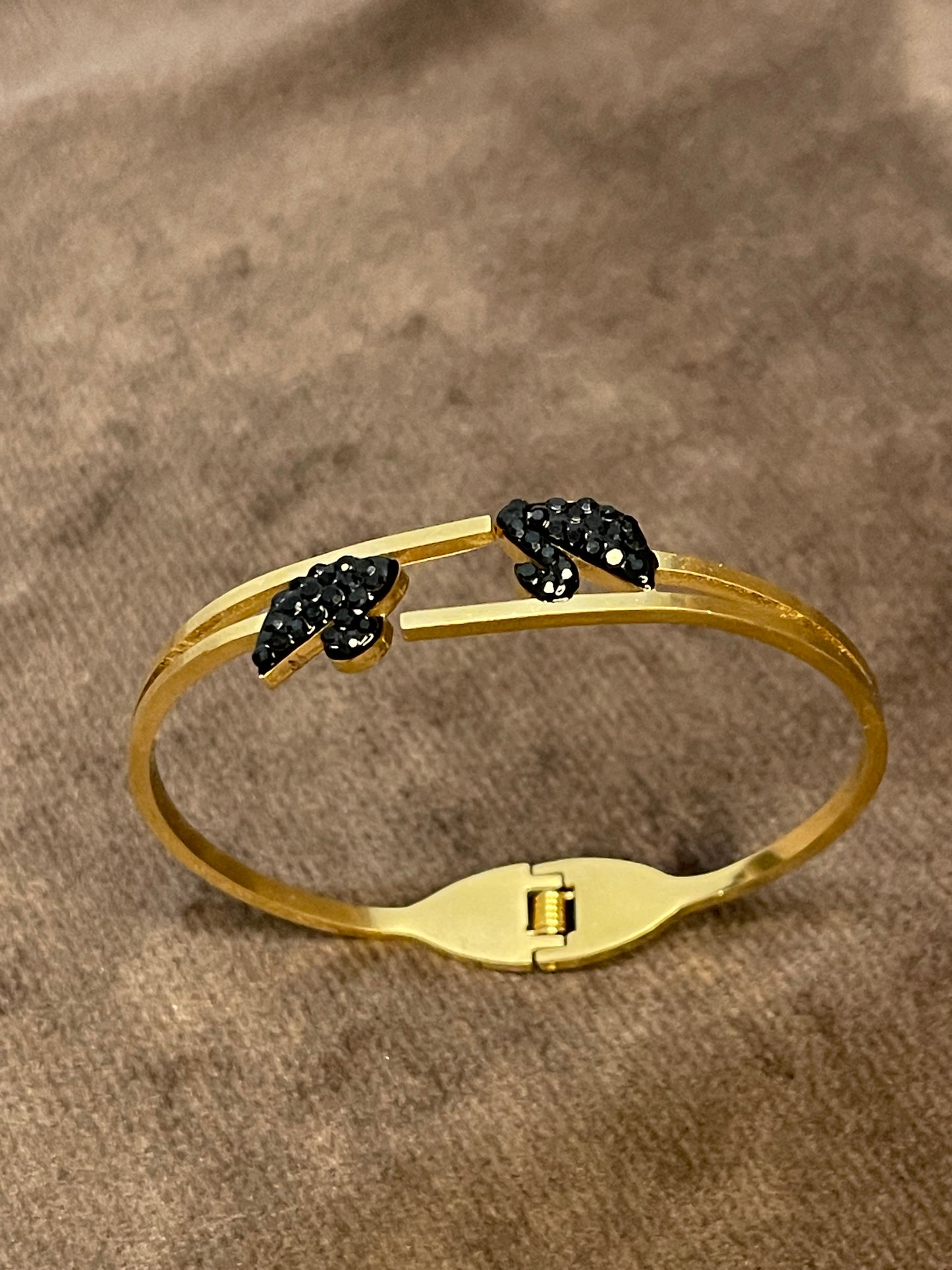Gold bangles with two black decorative ducks