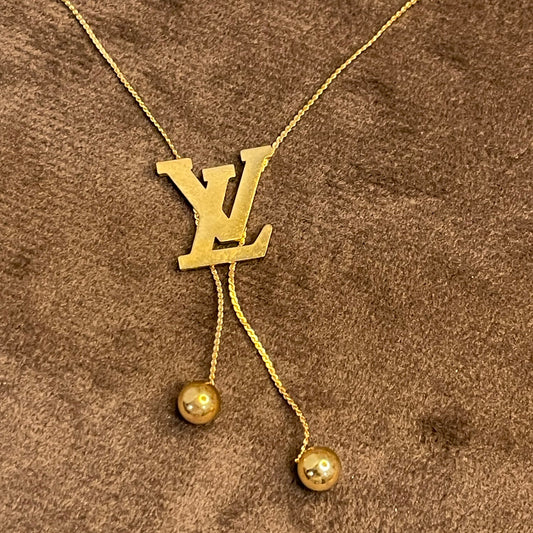 Gold Necklace with a Louis Vuitton (LV) logo.